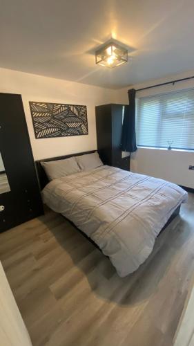 a bedroom with a large bed in a room at The Sauna House in Stockbury