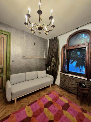 a living room with a couch and a window at Art Villa Bucharest in Bucharest