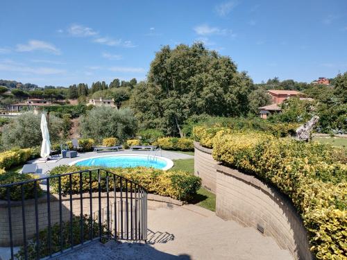 an external view of a garden with a swimming pool at Attico in Villa Dona in Sacrofano