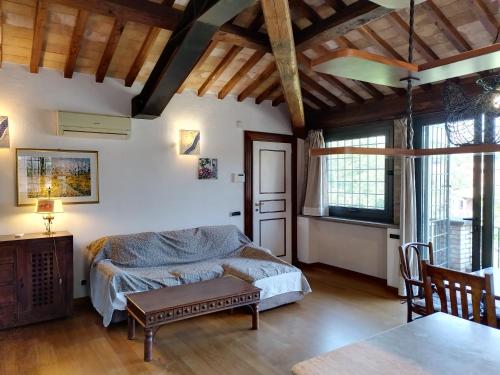 a bedroom with a bed and a table in a room at Attico in Villa Dona in Sacrofano