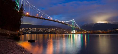 a bridge over a body of water at night at Highview Studio in Vancouver