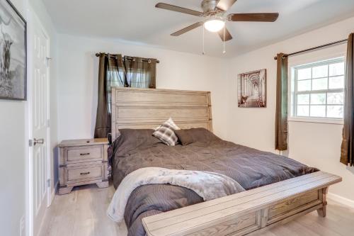 a bedroom with a bed and a ceiling fan at Riverfront Home with Porches and Views in Cotter! in Cotter