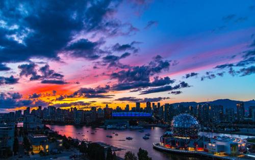 a sunset over a city with a river and buildings at Highview Studio in Vancouver