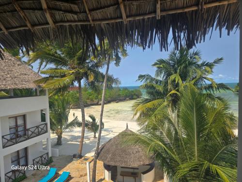 a view of the beach from the balcony of a resort at Ocean Bliss Beach Resort in Pongwe