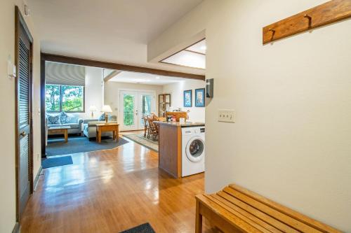 a kitchen and living room with a washer and dryer at Mountainside Villas at Massanutten by TripForth in McGaheysville