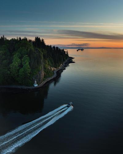 a boat in a body of water at sunset at Highview Studio in Vancouver