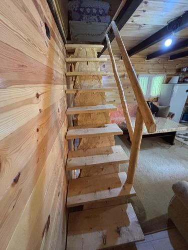 a wooden staircase in a room with a wall at Beco's Place in Plav