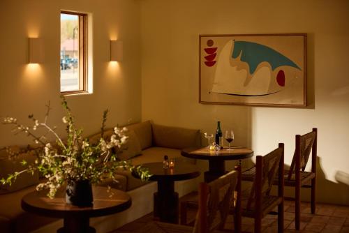 a living room with two tables and a couch at Hotel Willa in Taos