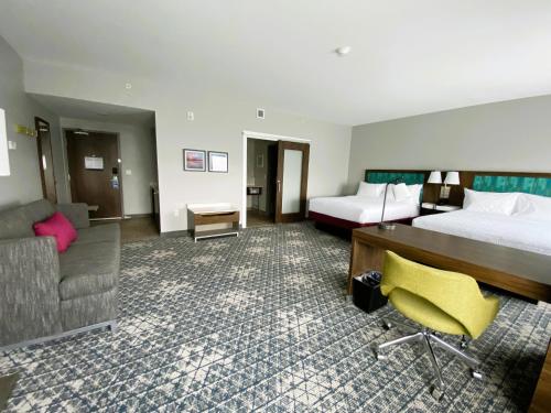 a hotel room with a bed and a couch at Hampton Inn & Suites Somerset in Somerset