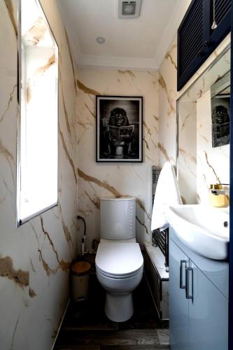 a bathroom with a toilet and a sink at Blue Haven House Sleeps 11 Garden & Parking in Orgreave
