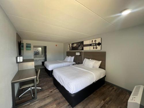 a hotel room with two beds and a desk at Westowne Inn Paducah I-24 Exit 4 in Paducah