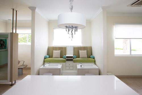 a waiting room with a green couch and a table at Windjammer Landing Resort and Residences in Gros Islet