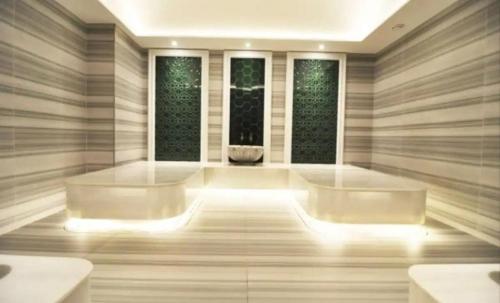 a large room with two large tubs and two windows at Luxury suites with gym pool high floor in Istanbul