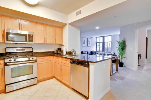 a kitchen with wooden cabinets and a stove top oven at Pentagon City Comfort Modern Stay in Arlington