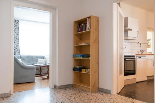 a kitchen with a book shelf next to a living room at Ferienwohnung Engel in Laa an der Thaya