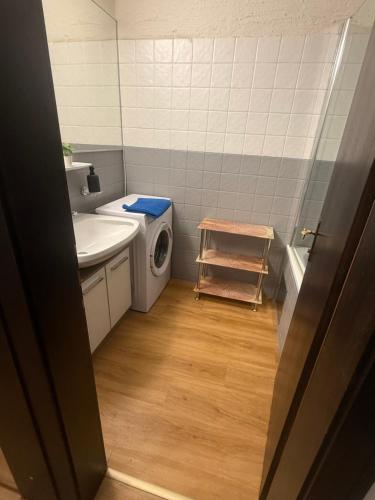 a bathroom with a washing machine and a sink at Andys Enzian in Leutasch