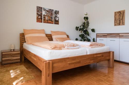 a bedroom with a wooden bed in a room at Ferienwohnung Engel in Laa an der Thaya