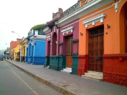a row of brightly colored buildings on a street at Hotel Park Suites in Lima
