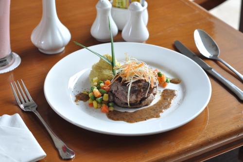 a white plate of food on a table at Dreamtel Jakarta in Jakarta