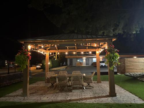 a gazebo with a table and chairs at night at VIP Motel in Parksville
