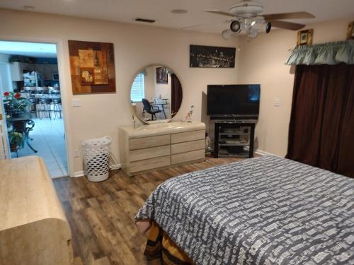a bedroom with a bed and a flat screen tv at TheTotal Florida life style heated pool 5 bedrooms in Punta Gorda