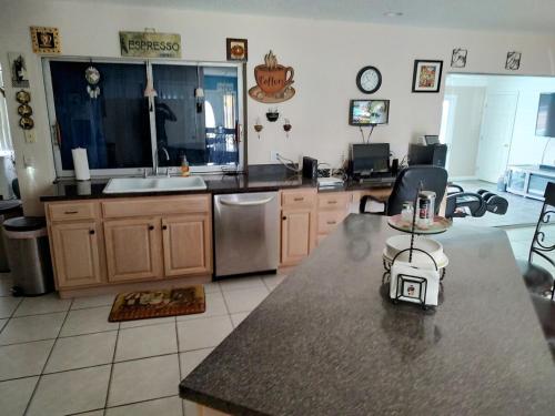 a kitchen with a sink and a counter top at TheTotal Florida life style heated pool 5 bedrooms in Punta Gorda