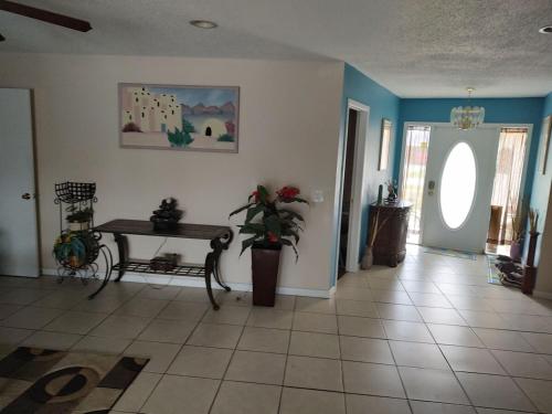 a living room with a table and a table at TheTotal Florida life style heated pool 5 bedrooms in Punta Gorda