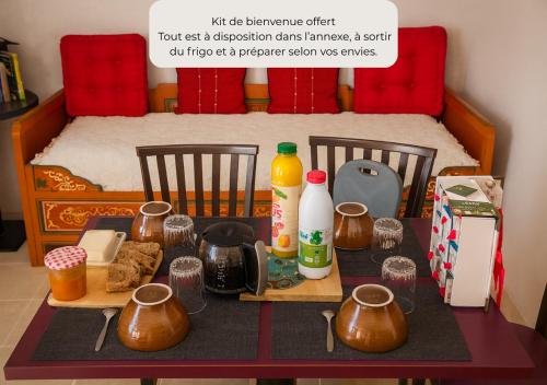 a table with food and containers on it with a bed at Yourte mongole insolite en pleine nature in Pouilly-sous-Charlieu