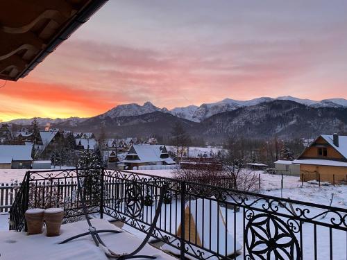 a view from the balcony of a town in the snow at Villa z widokiem na Giewont in Kościelisko
