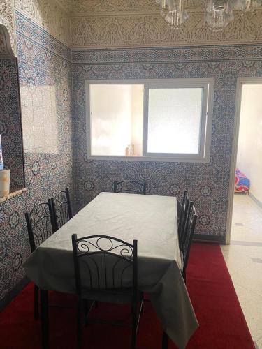 a dining room with a table and a window at Hassania in Azrou