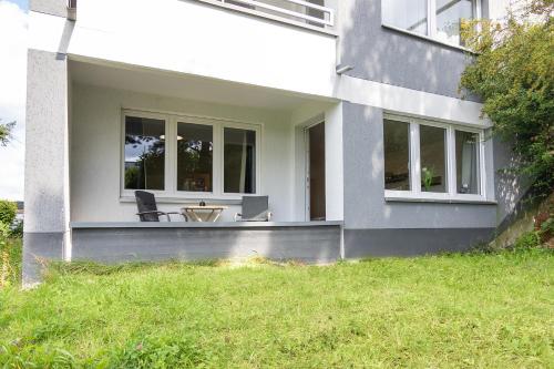 a house with two chairs and a table on the porch at Ferienwohnungen Riese - Sternenzauber in Arnsberg