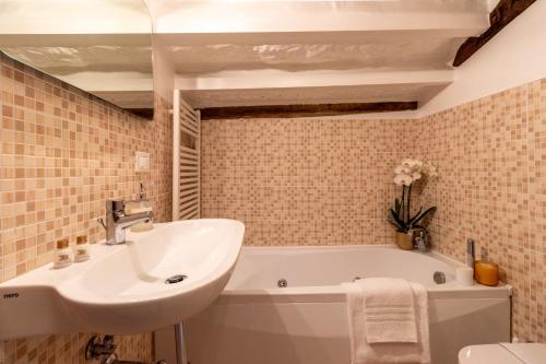 a bathroom with a sink and a bath tub at B&B Luxury San Firmino Canal View in Venice