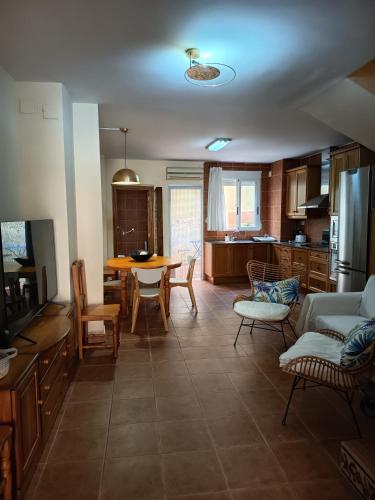 a kitchen and living room with a table and chairs at La Senia in Moncófar