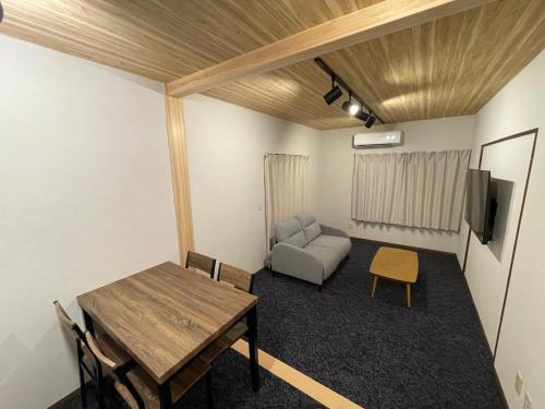 a living room with a table and a couch at Guest house TOMORI - Vacation STAY 11064v in Shingū
