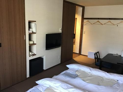 a hotel room with a bed and a television at K,M,H Art hotel by Kure Morisawa - Vacation STAY 11399v in Kure