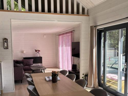 a dining room with a table and a living room at 5 star holiday home in UGGLARP in Ugglarp
