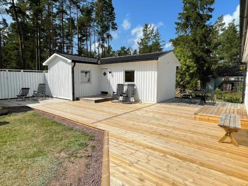 a backyard with a wooden deck and a building at 4 star holiday home in Mönsterås-By Traum in Mönsterås