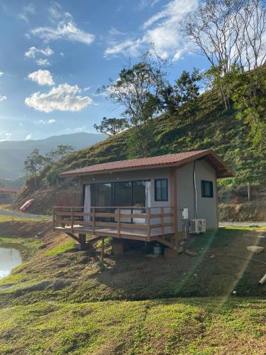 a small house on a hill with a grassy slope at Fazenda - Lago in São José dos Campos