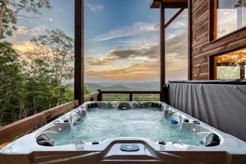 a jacuzzi tub on a deck with a view at Big Sky - Best Views in Blue Ridge in Epworth