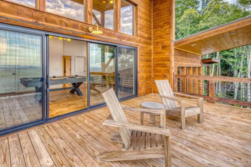 a cabin with two chairs and a table on a deck at Big Sky - Best Views in Blue Ridge in Epworth