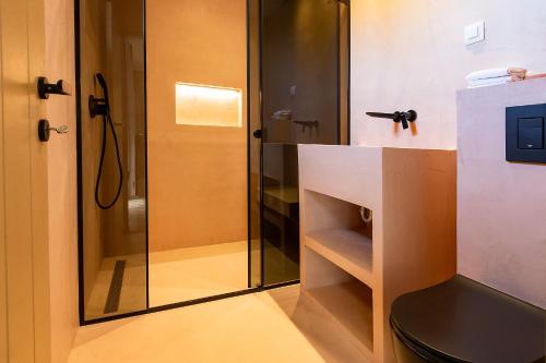 a bathroom with a glass shower and a toilet at Zorka in Budva