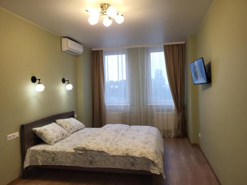 a small bedroom with a bed and a window at ЖК Bridge Tower in Rivne