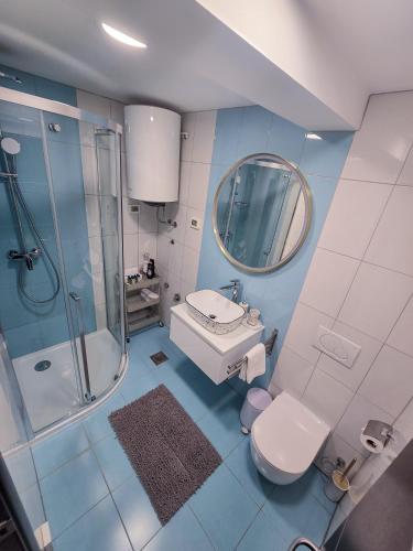 a bathroom with a sink toilet and a mirror at La Riva Apartment Sea View in Rovinj