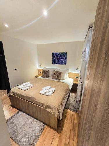 a bedroom with a bed with two towels on it at La Riva Apartment Sea View in Rovinj