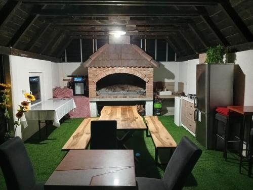 a kitchen with a large fireplace in the middle of a room at Resort La Familia in Bihać