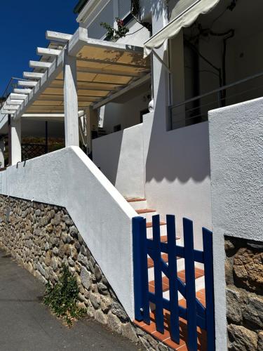 a blue fence in front of a house at Da Elisa in Chiessi