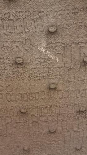 a close up of a stone wall with writing on it at Pantelia LuxMax Experience in Loutraki