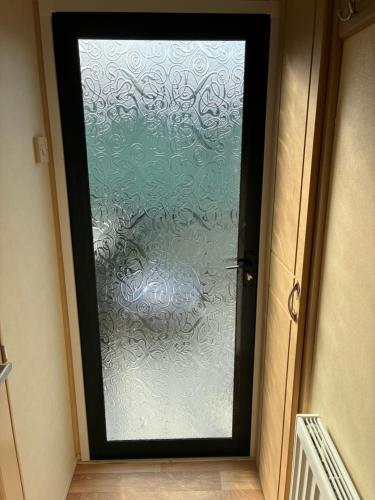 a door with a glass door with a window at Slaley Forest Hexham Caravan Retreat Pet Friendly - sleeps 6 in Slaley