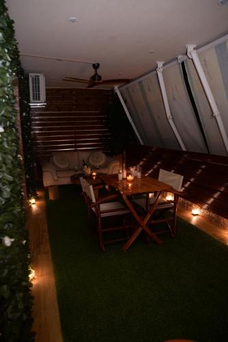 a room with a table and a couch with lights at Pantelia LuxMax Experience in Loutraki
