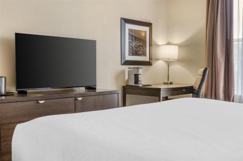 a hotel room with a bed and a flat screen tv at Best Western Plus Bridgewater Hotel & Convention Centre in Bridgewater